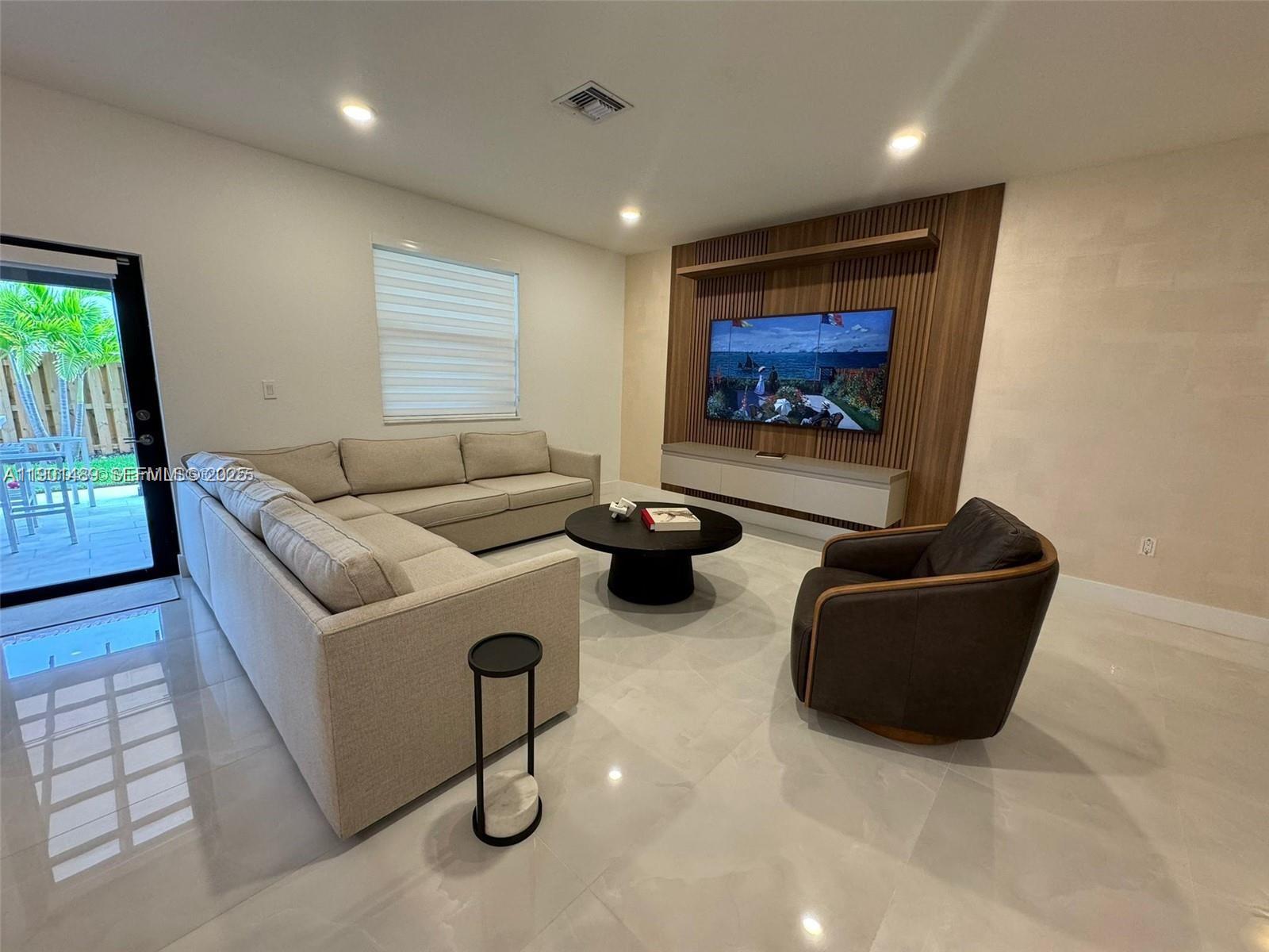 11910 Southwest 243rd Street Homestead, FL 33032 - Photo 20 of 24 a living room with furniture and a flat screen tv