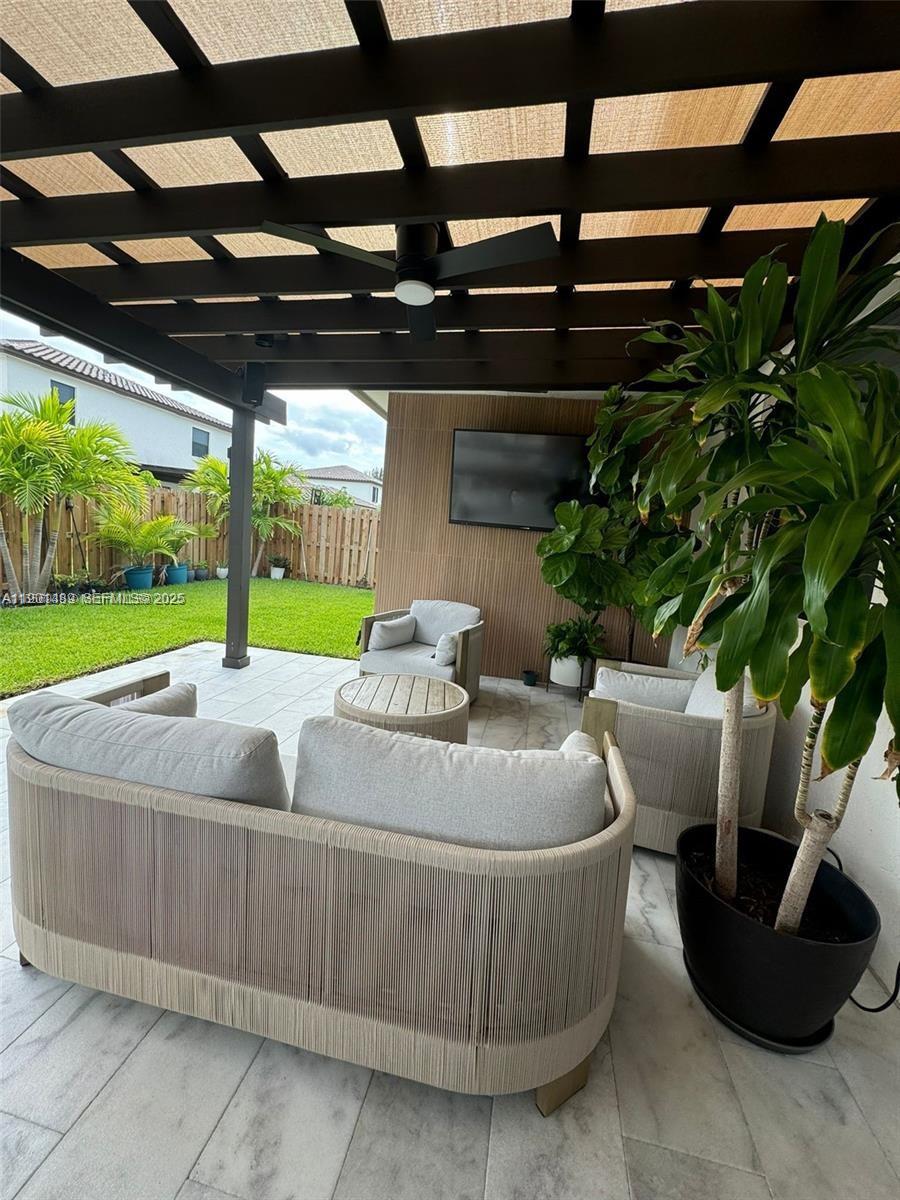 11910 Southwest 243rd Street Homestead, FL 33032 - Photo 2 of 24 a roof deck with table and chairs and potted plants
