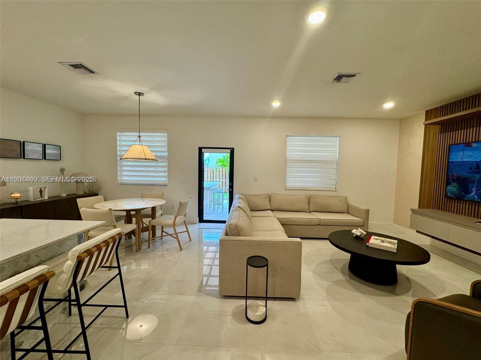 11910 Southwest 243rd Street Homestead, FL 33032 - Photo 21 of 24 a living room with furniture and a flat screen tv