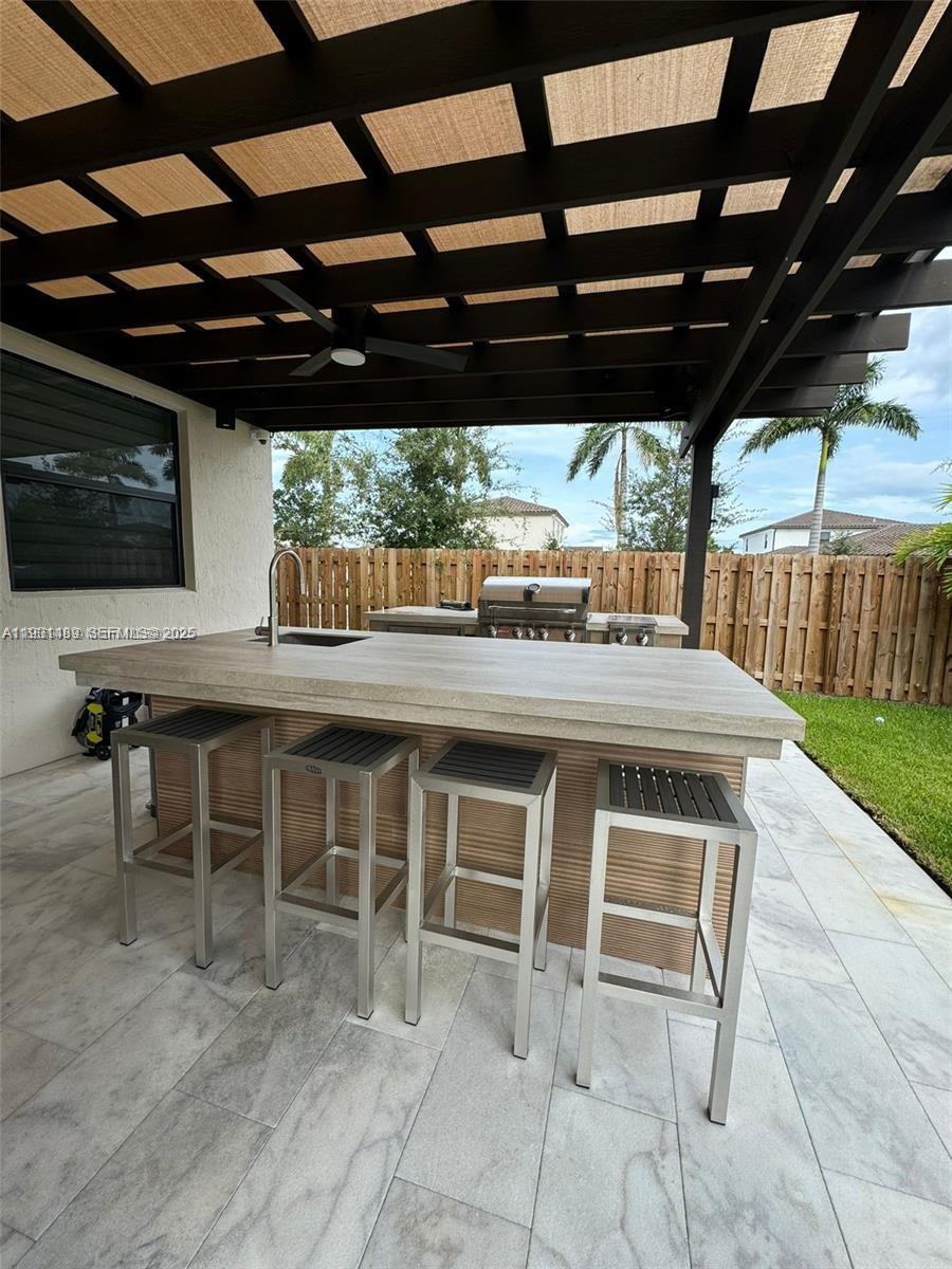 11910 Southwest 243rd Street Homestead, FL 33032 - Photo 4 of 24 a view of a chairs and table in the patio with a backyard
