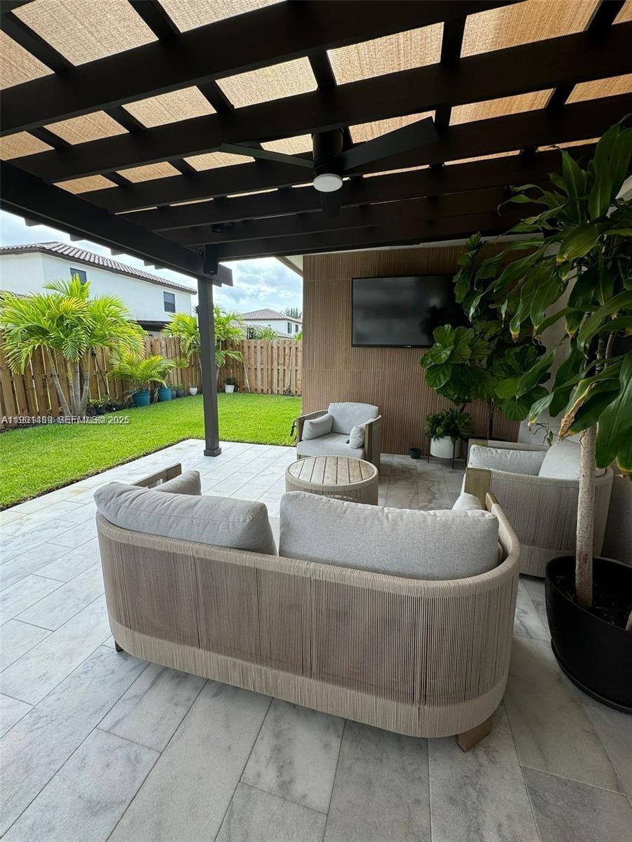 11910 Southwest 243rd Street Homestead, FL 33032 - Photo 5 of 24 a living room with a couch and a garden