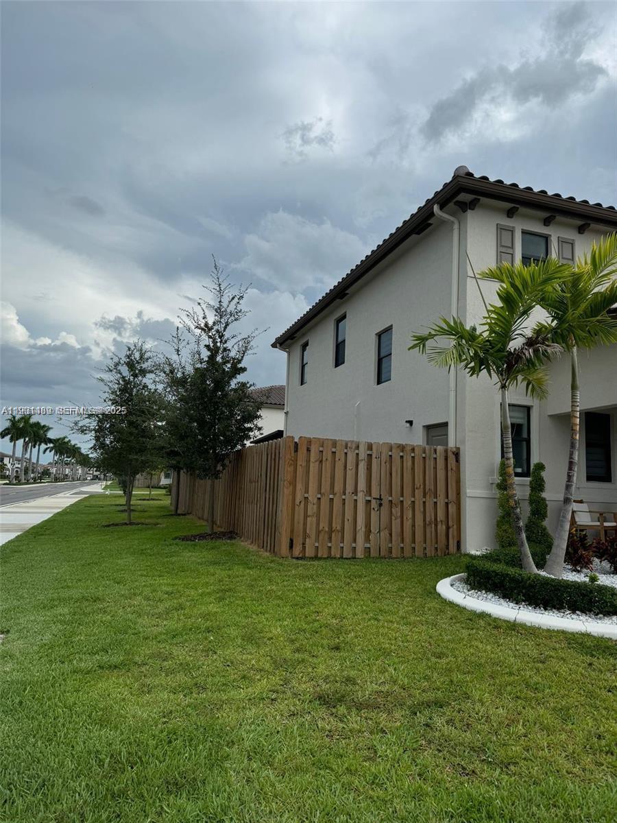11910 Southwest 243rd Street Homestead, FL 33032 - Photo 8 of 24 a view of a house with a yard and plants