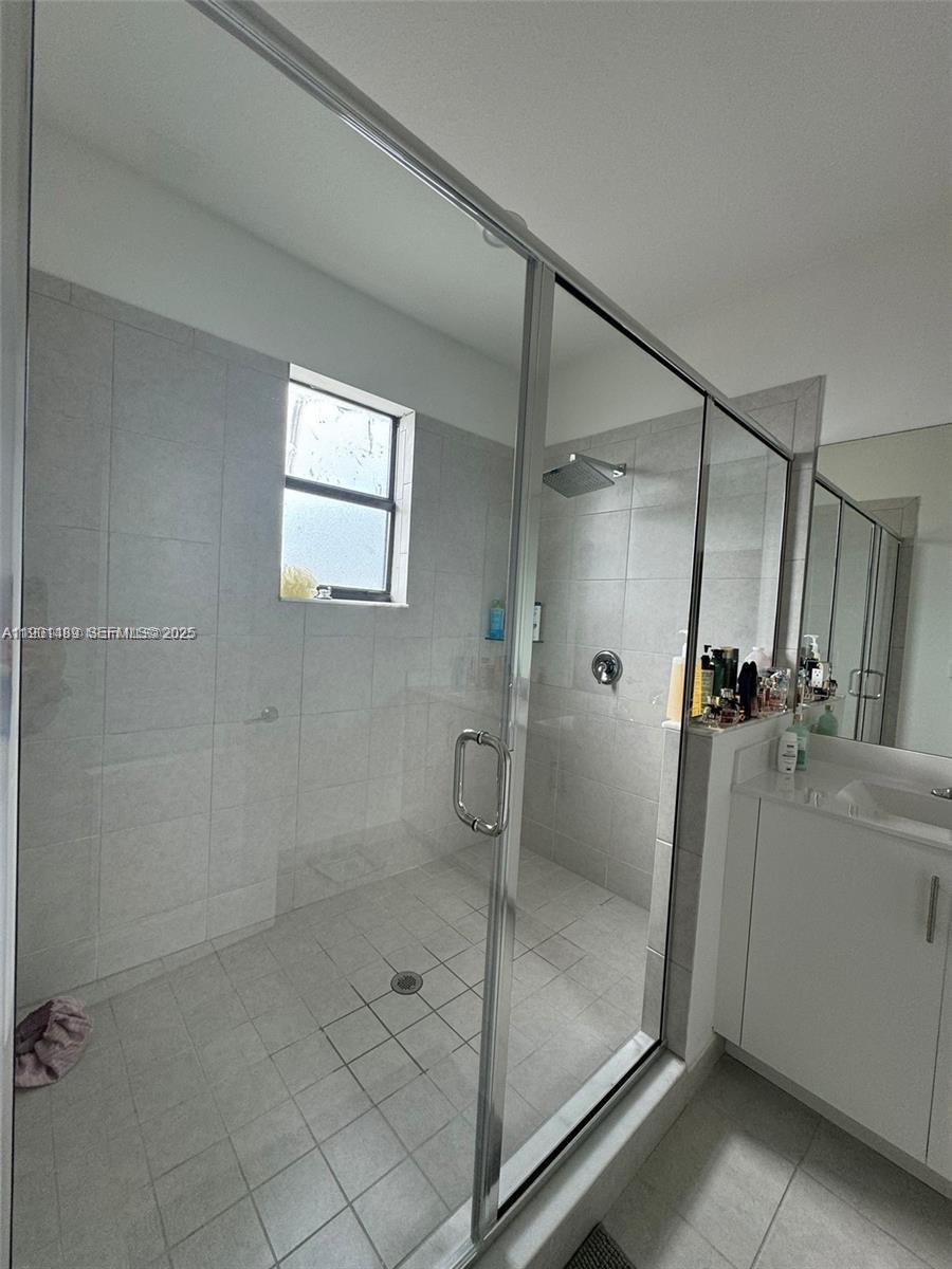 11910 Southwest 243rd Street Homestead, FL 33032 - Photo 9 of 24 a bathroom with a glass shower door