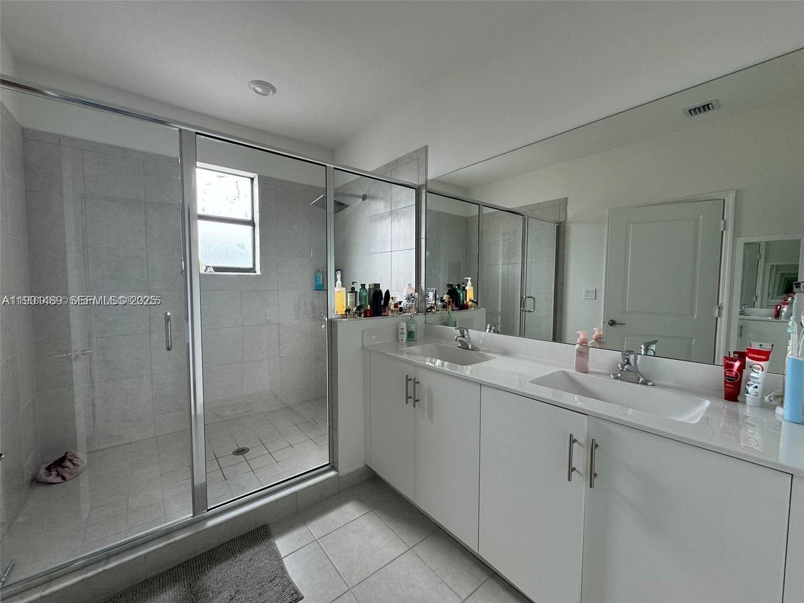 11910 Southwest 243rd Street Homestead, FL 33032 - Photo 10 of 24 a bathroom with a shower sink and mirror