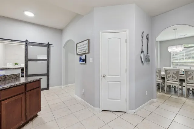 a spacious bathroom with a granite countertop sink a mirror and a shower