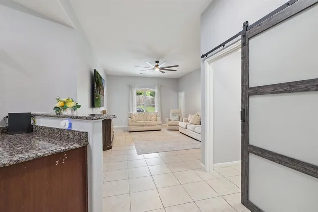 a kitchen with stainless steel appliances granite countertop a sink and a refrigerator