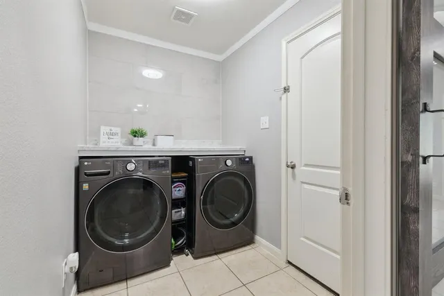 a utility room with sink dryer and washer