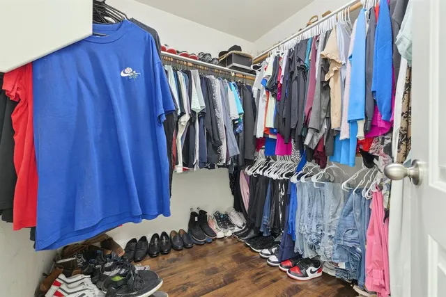 a view of walk in closet with clothes
