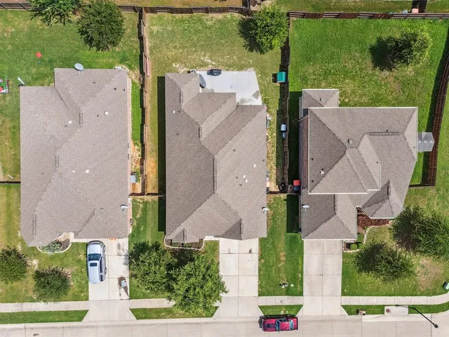 an aerial view of residential houses with outdoor space and city view