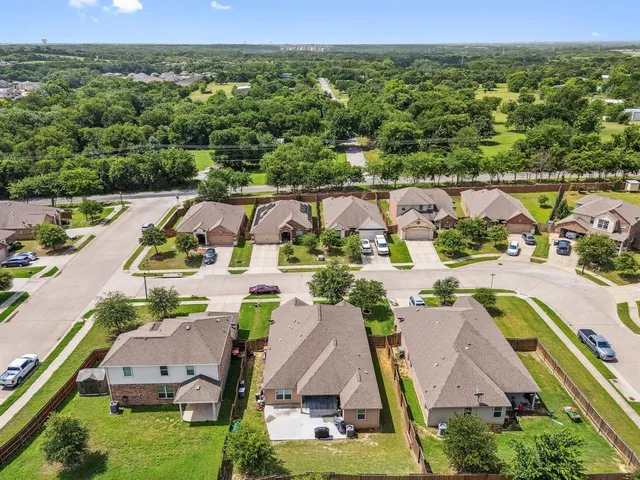 an aerial view of residential houses with outdoor space