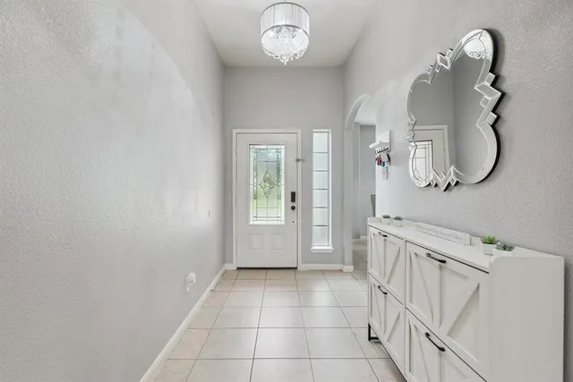 a spacious bathroom with a mirror a sink and a shower