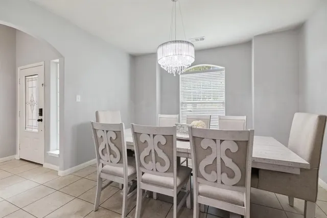 a view of a dining room with furniture wooden floor and chandelier