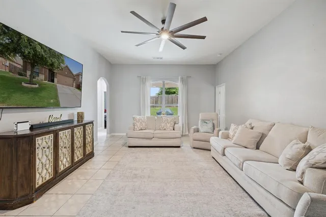a living room with furniture and flat screen tv