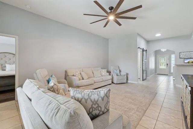 a living room with furniture and a chandelier
