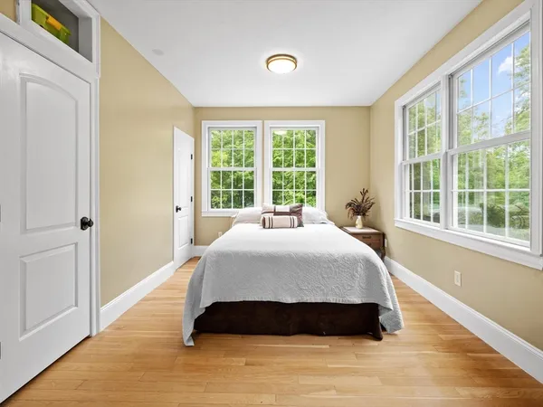 a spacious bedroom with a bed and a window