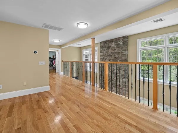 a view of a room with wooden floor and fence