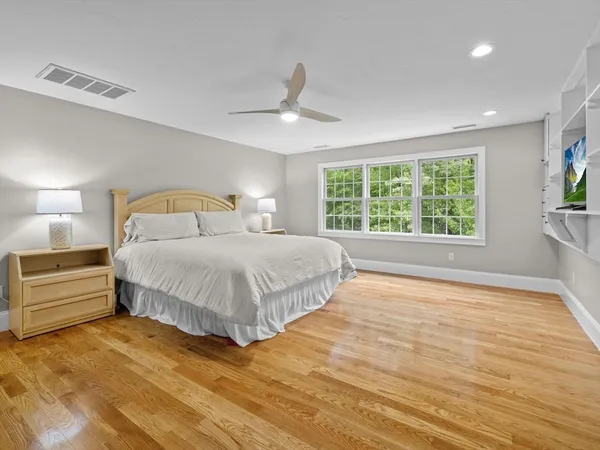 a bedroom with a large bed and a window