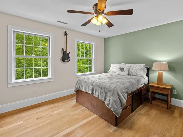 a spacious bedroom with a bed and a window