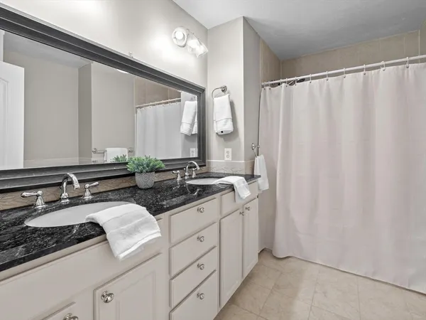 a bathroom with a double vanity sink and mirror