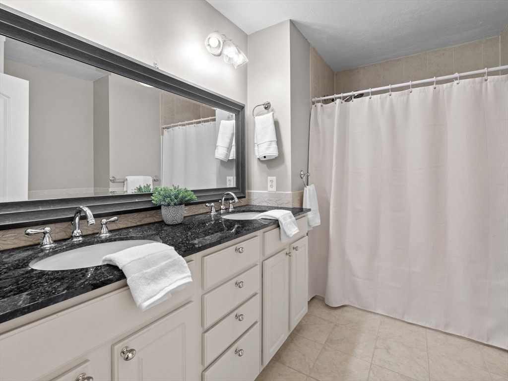 12 Breton Road Upton, MA 01568 - Photo 28 of 42 a bathroom with a double vanity sink and mirror