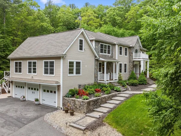 a aerial view of a house with porch and sitting area