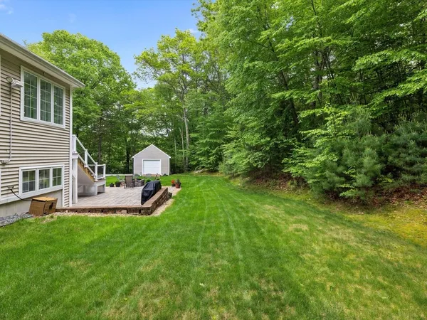 a view of a backyard with plants and patio