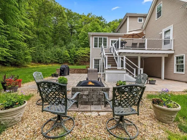 a view of a patio with a table and chairs potted plants