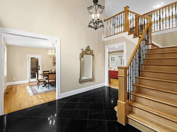 a view of a hallway with wooden floor and windows