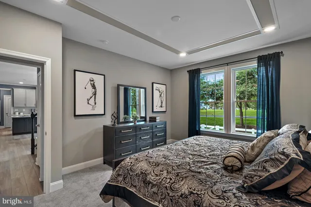 a bedroom with a bed and large windows