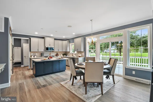 a dining room with furniture and wooden floor