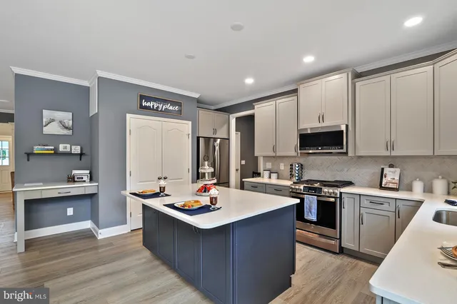 a kitchen with a sink stove and wooden cabinets