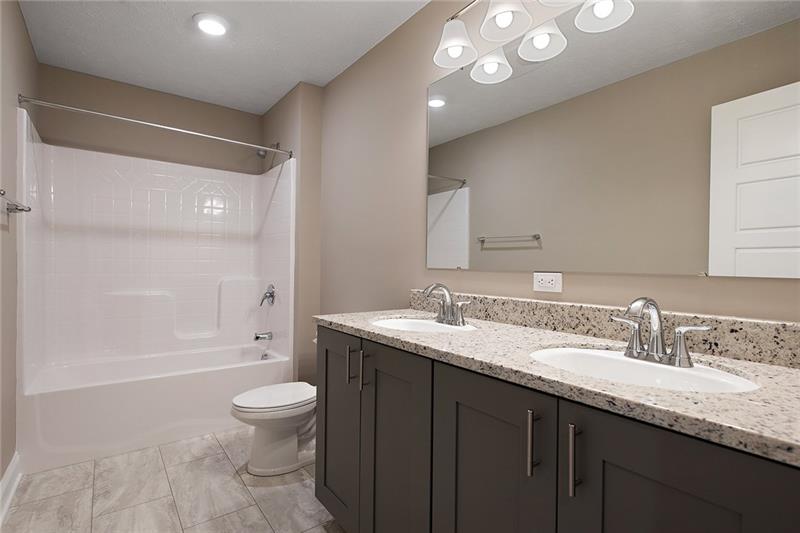 193 Witherow Road Sewickley, PA 15143 - Photo 19 of 25 The shared bathroom for bedrooms 2 and 3 has a tile floor, granite counter tops, dual sinks and a tub/shower combo.