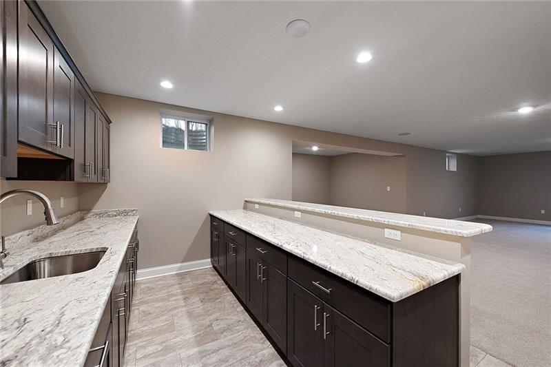 193 Witherow Road Sewickley, PA 15143 - Photo 24 of 25 The finished lower level has a wet bar with granite counter tops and an island for additional seating.