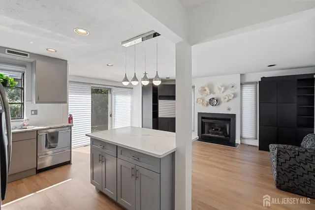 a kitchen with cabinets and wooden floor