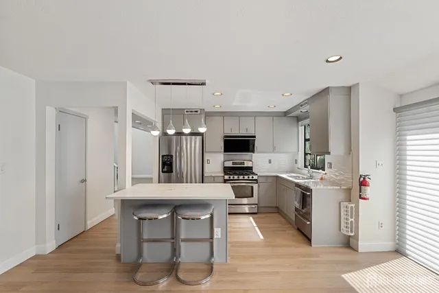 a kitchen with cabinets a counter and appliances