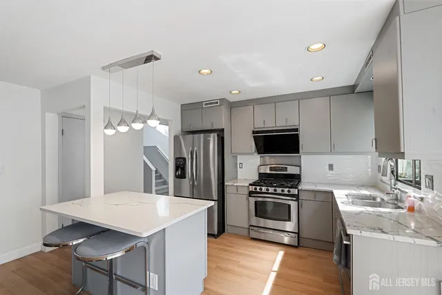 a kitchen with a sink stainless steel appliances and cabinets