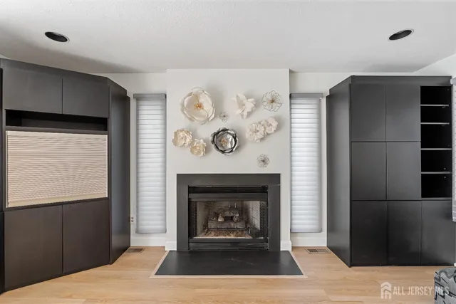 a living room with a fireplace and a wooden floor