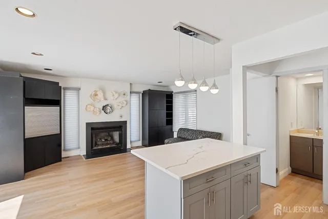 a kitchen with a sink a fireplace and cabinets