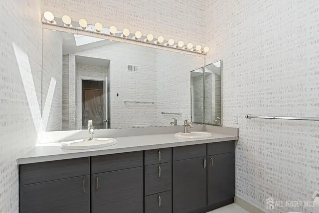 a view of an empty room with a fireplace and entryway