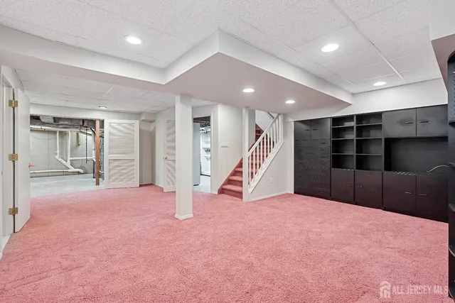 a view of an empty room with a bathroom and a sink