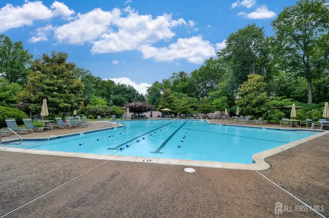 a living room with furniture and a dining table with wooden floor