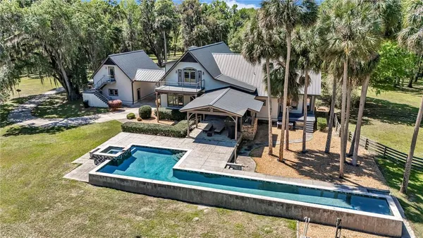 a front view of house with yard outdoor seating and barbeque oven