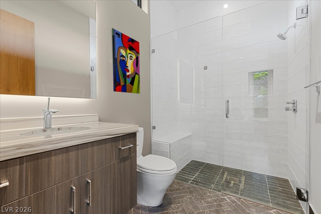 657 Ridgestone Rim Court Henderson, NV 89012 - Photo 71 of 97 Clean lines and a glass-enclosed walk-in shower define this modern, well-appointed bathroom.