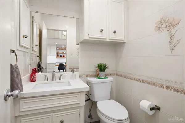 a bathroom with a sink a toilet and vanity