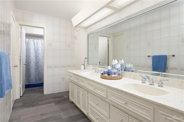 a bathroom with a double vanity sink and a mirror