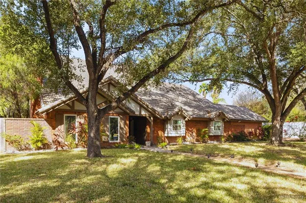 a view of a big house with large trees