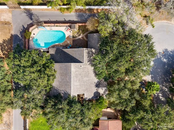 an aerial view of a house with a yard