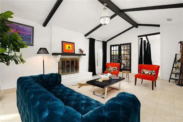 a living room with furniture fireplace and flat screen tv