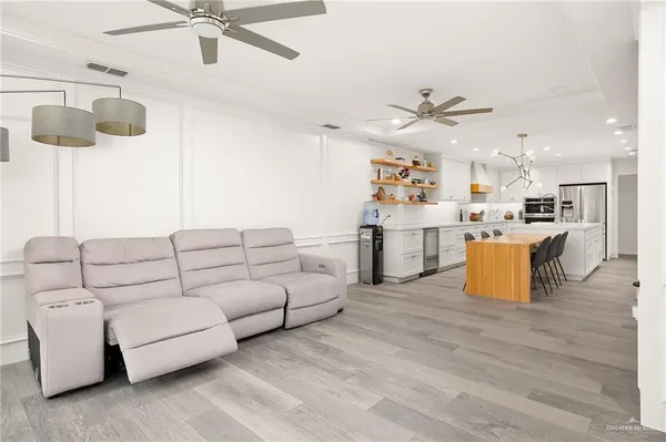 a living room with furniture and kitchen view