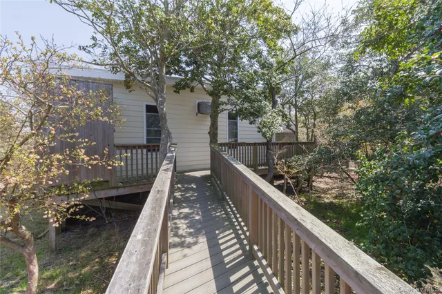 a view of balcony with wooden floor and fence